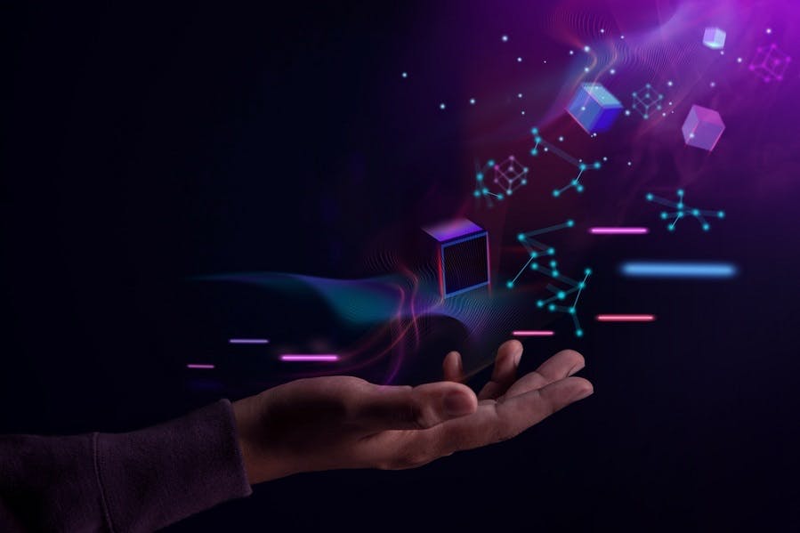 Web 3 stock image featuring a hand held out with cubes and glowing dots floating above it.